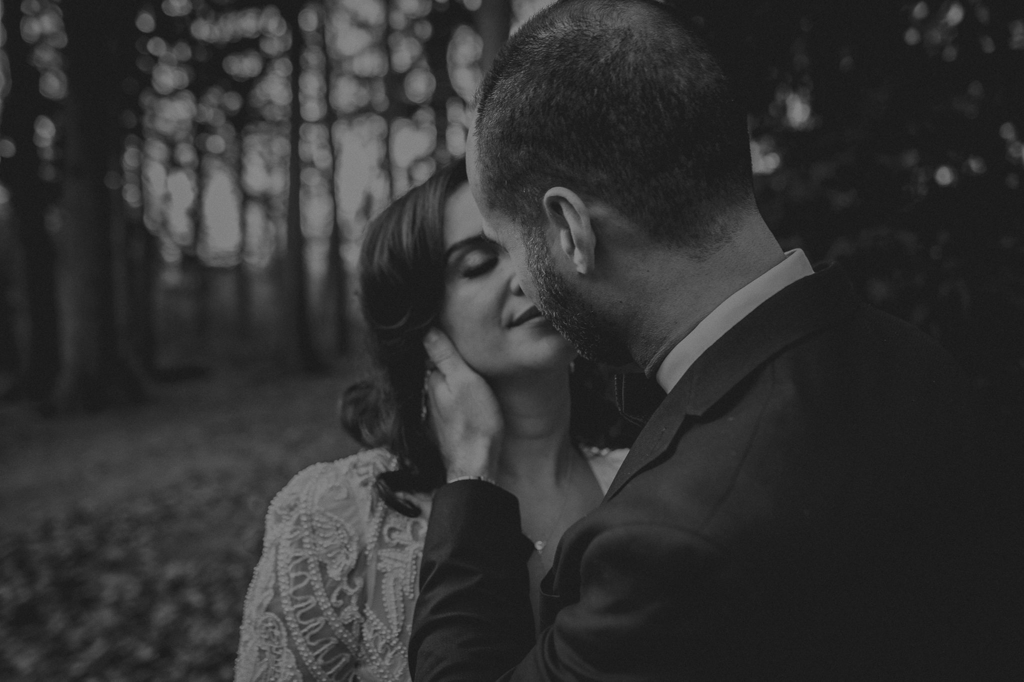bride and groom embrace in a kiss