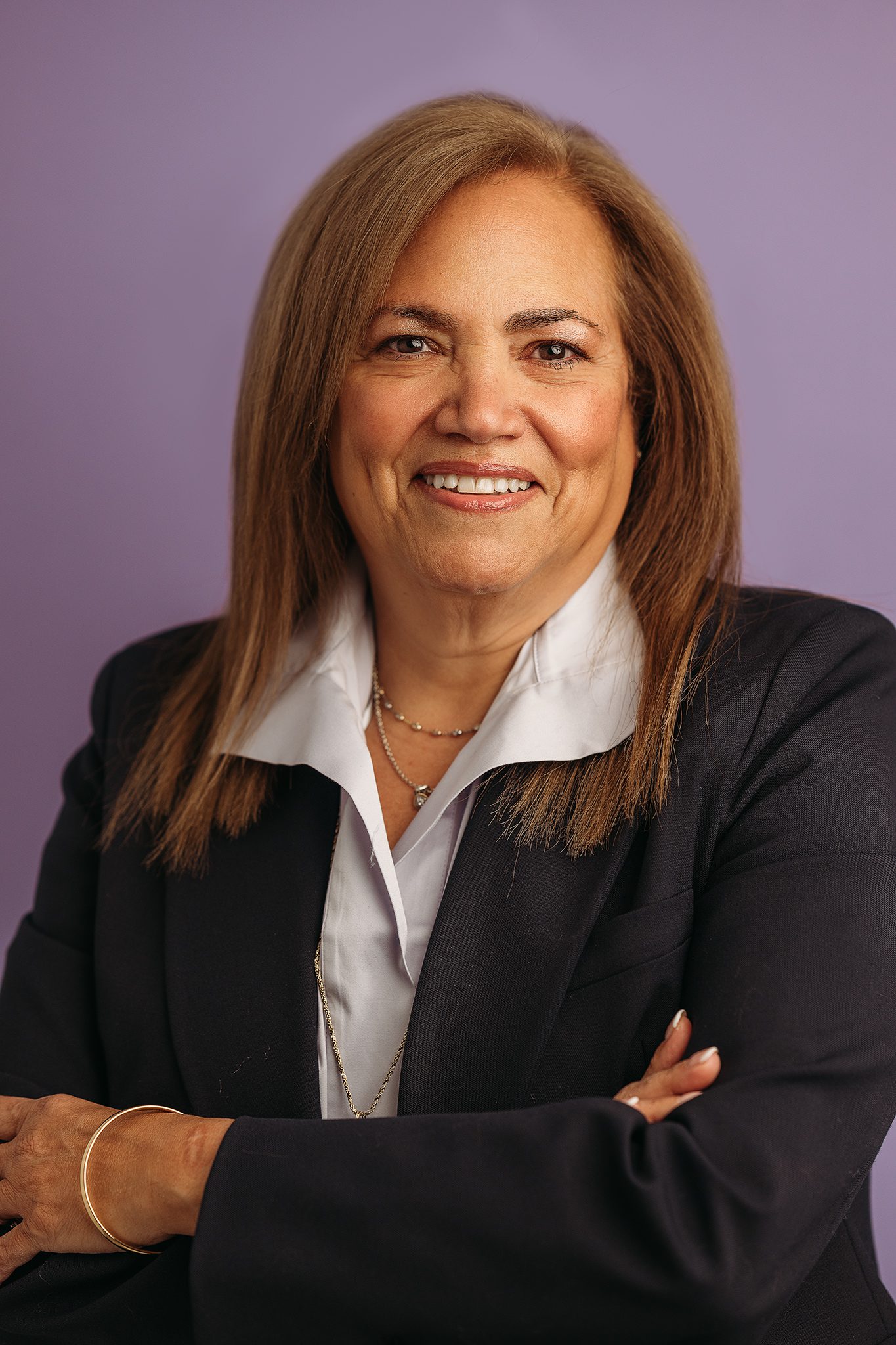 Professional woman headshot infront of colorful lilac backdrop