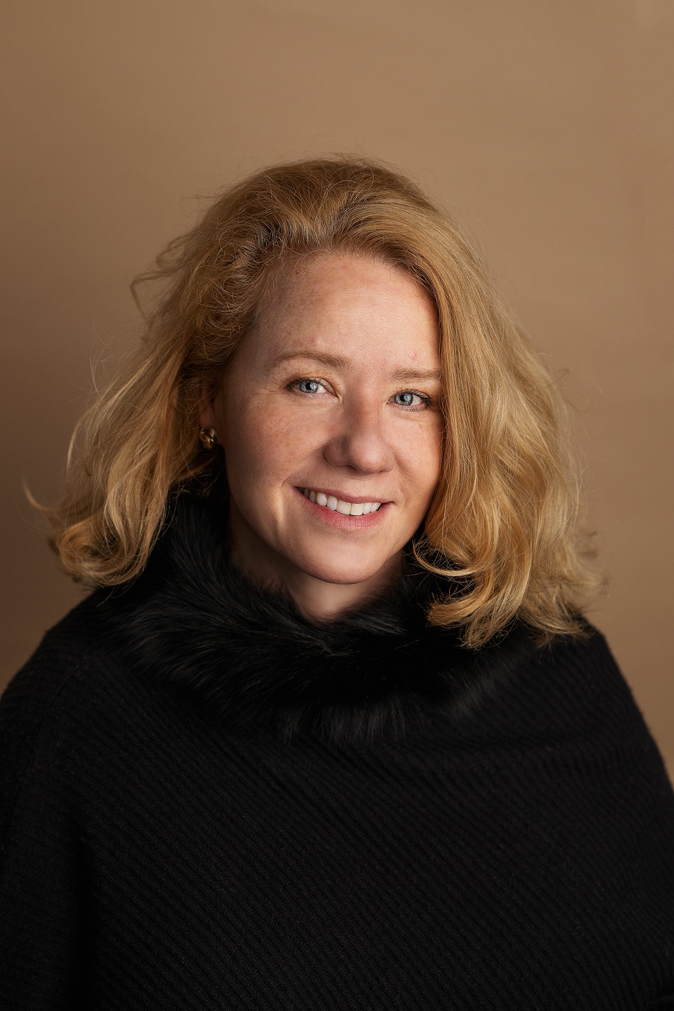 woman headshot on tan background