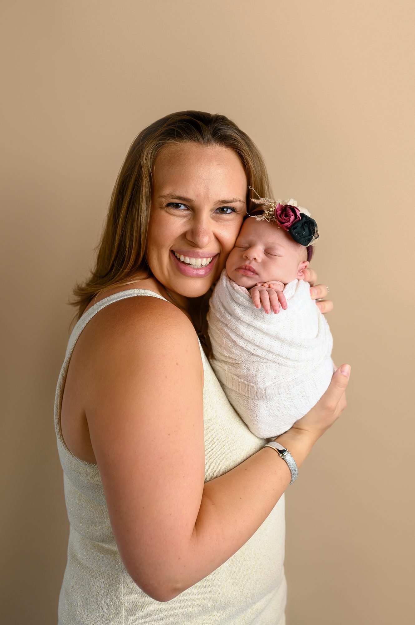 mom holding his new baby girl at her scotch plains studio newborn session in scotch plains nj
