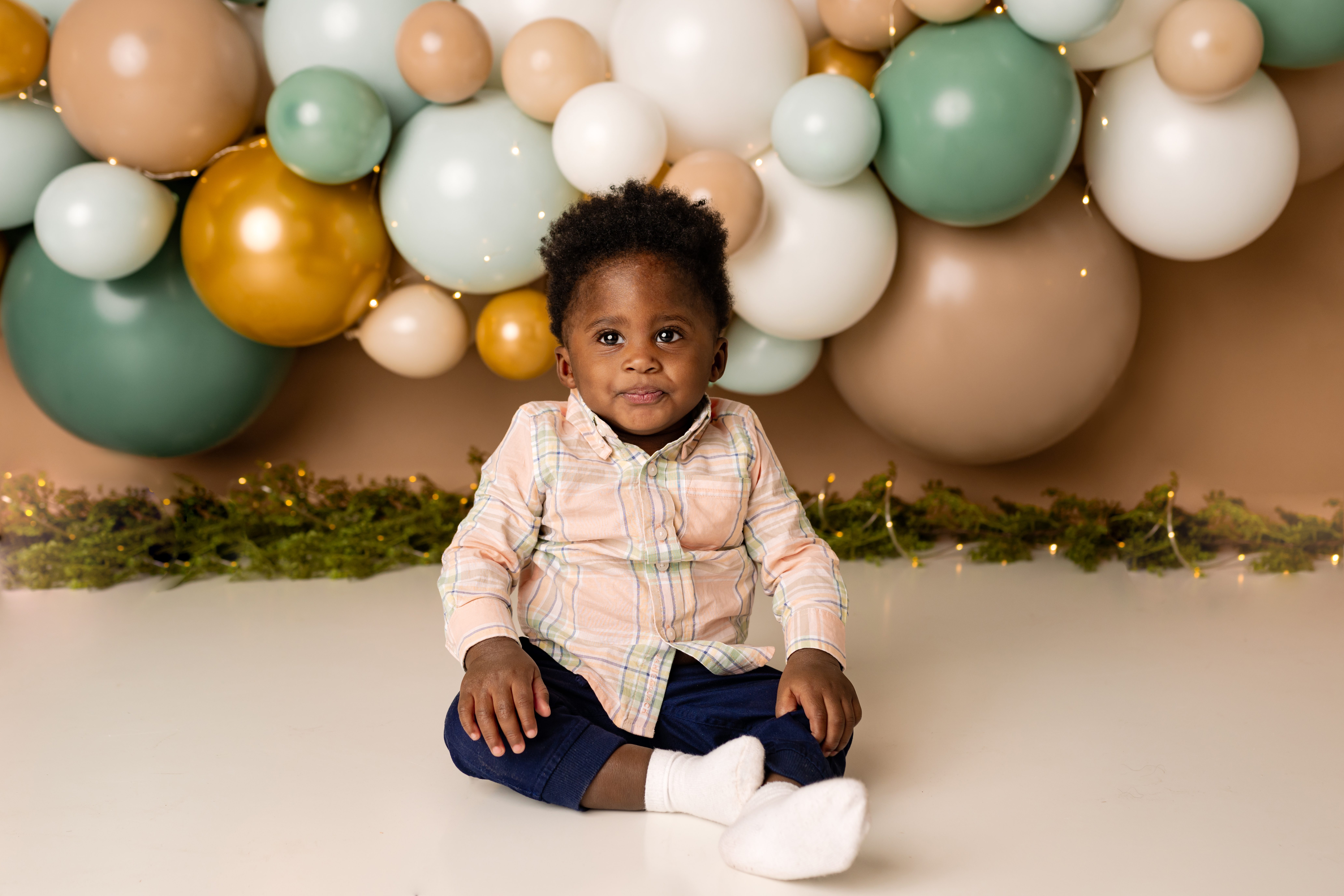 little boy first birthday with balloons behind him with scotch plains nj photographer