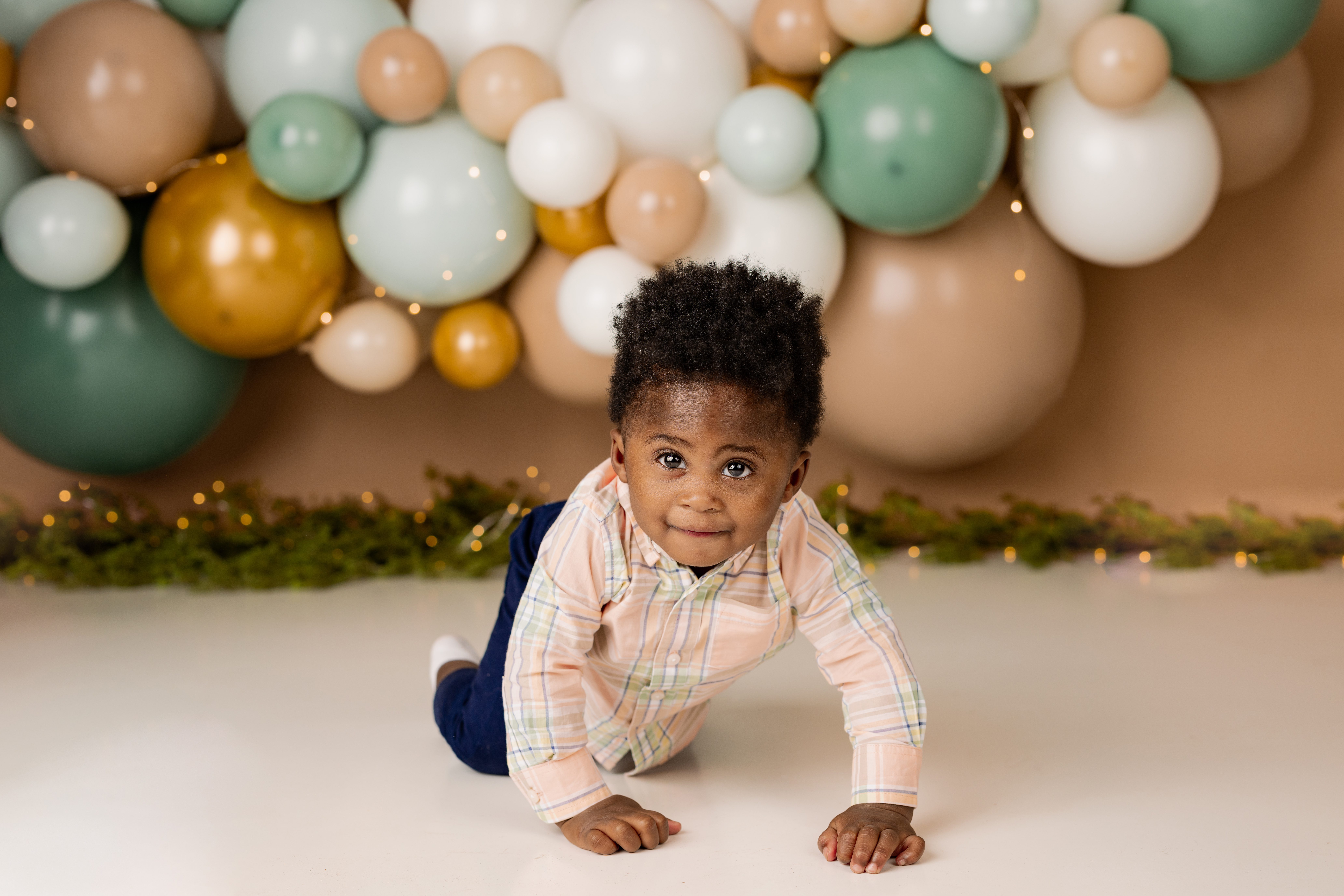 little boy first birthday with balloons behind him with scotch plains nj photographer