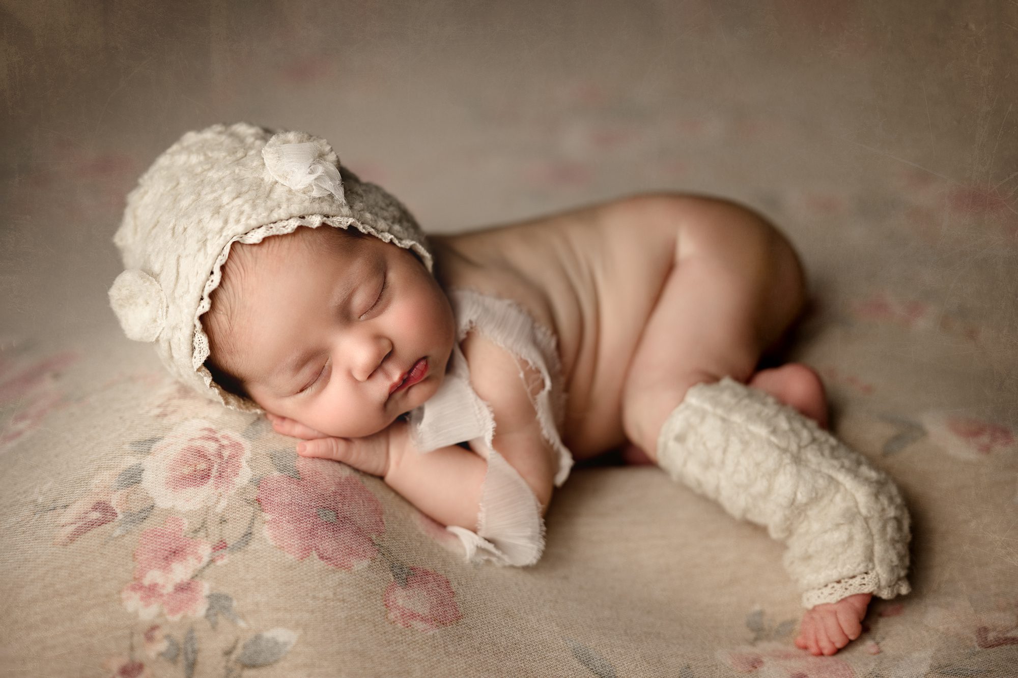 newborn girl on a floral backdrop at photoshoot with joan marie photography in scotch plains nj