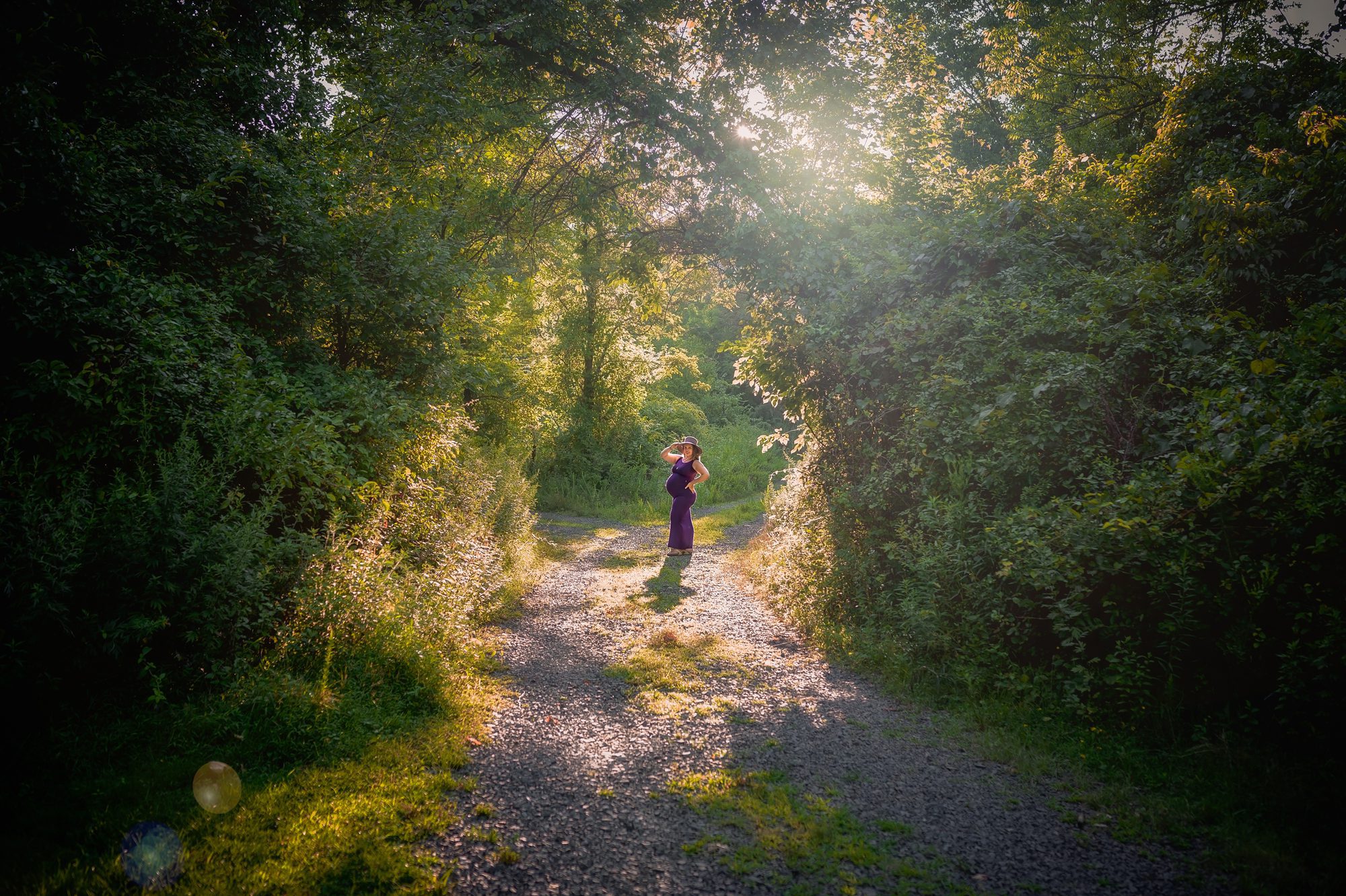 mom poses in the sunset at her outdoor maternity shoot in scotch plains
