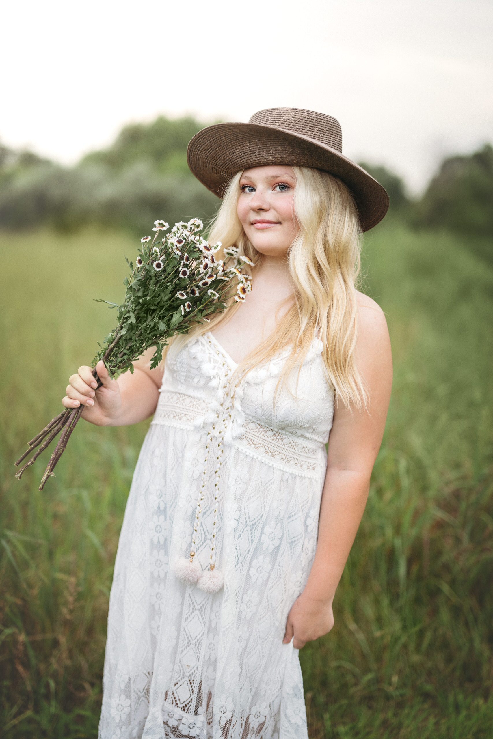 High School Senior stands in field with flowers in Hillsborough NJ with Scotch Plains Senior Photographer Joan Marie