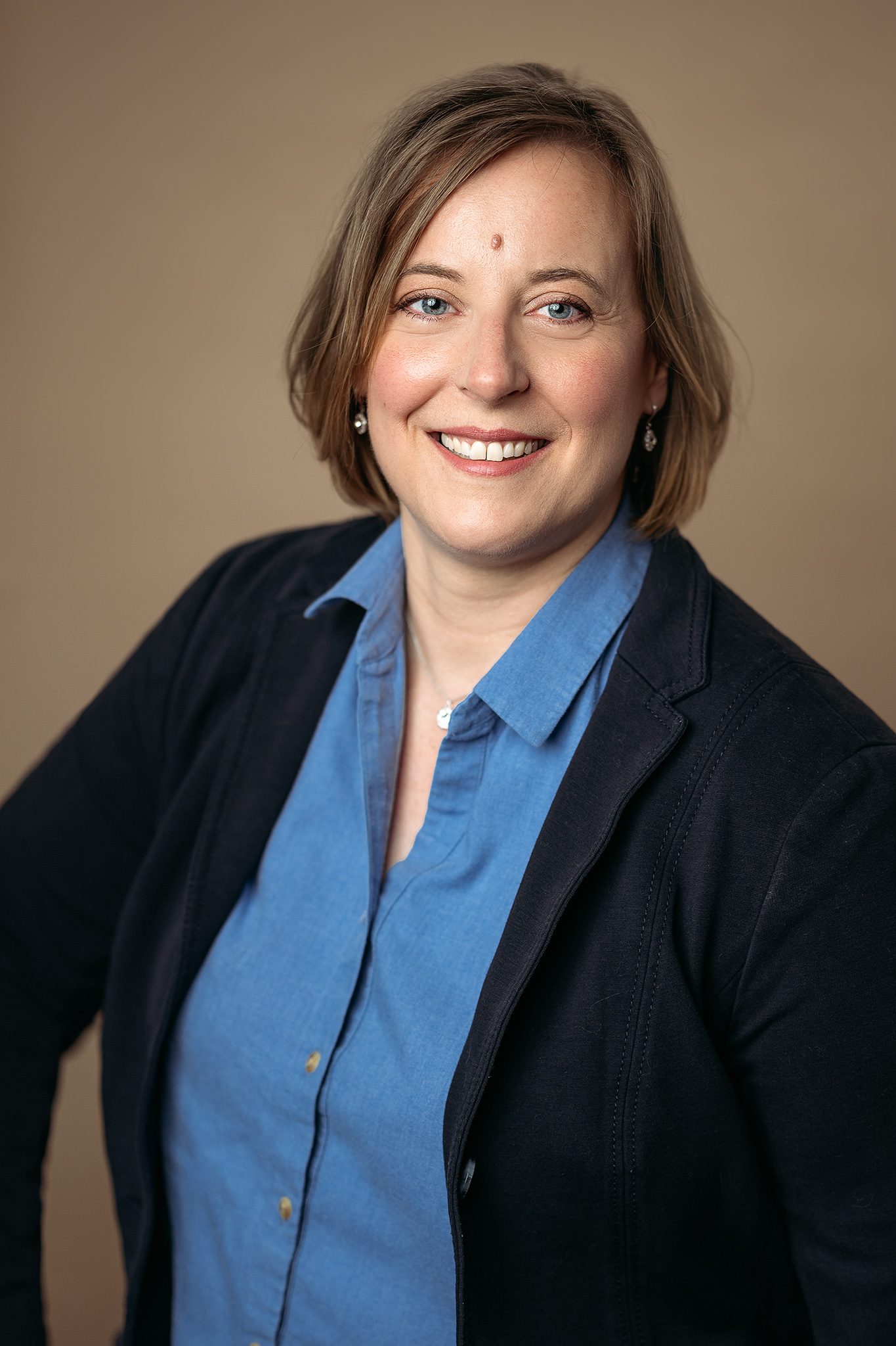 woman headshot on tan background