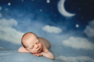 Newborn Photoshoot in Scotch Plains with a newborn baby on a backdrop of stars and moon