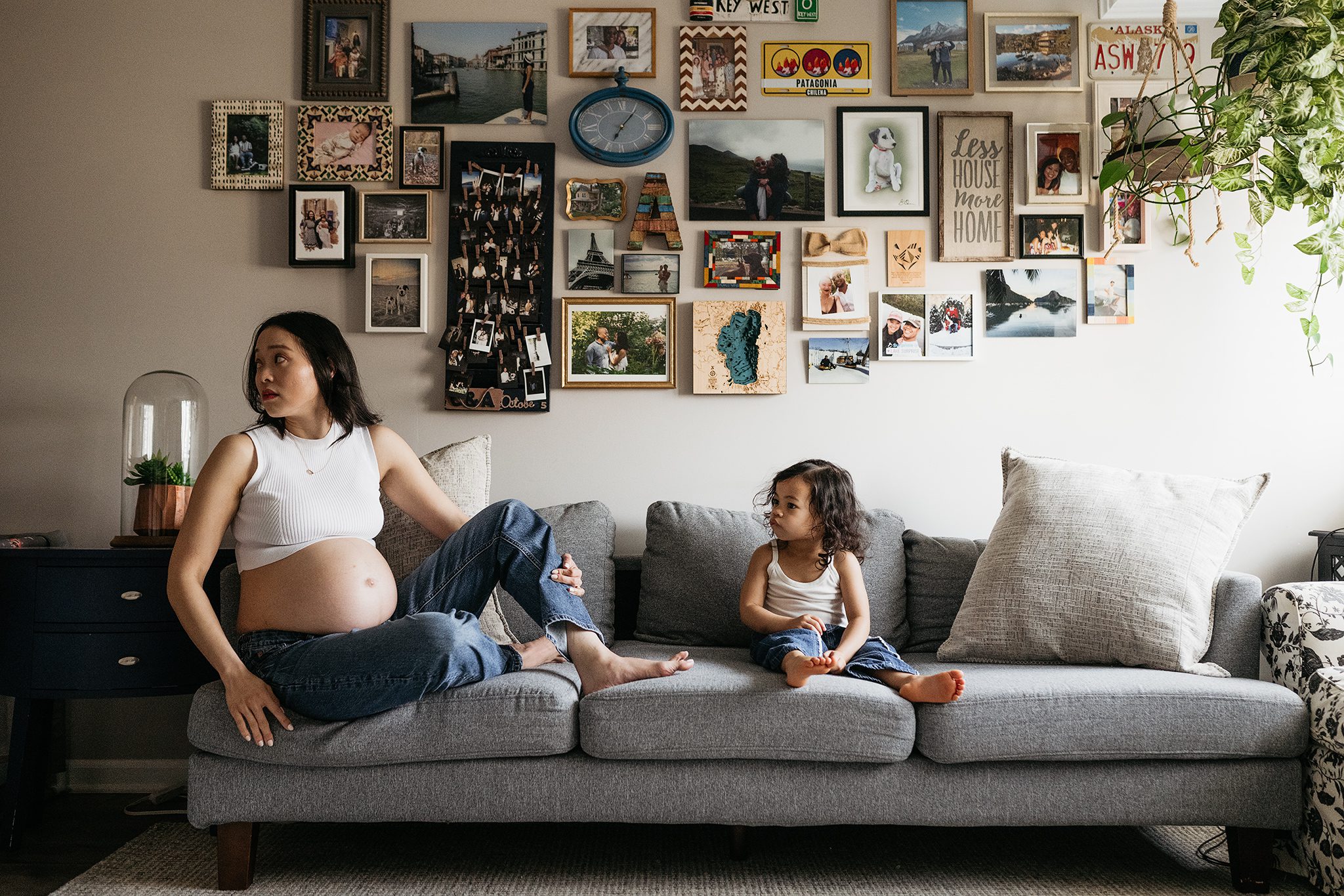 mom and daughter sit on couch at their in-home maternity session with joan marie photography in scotch plains nj