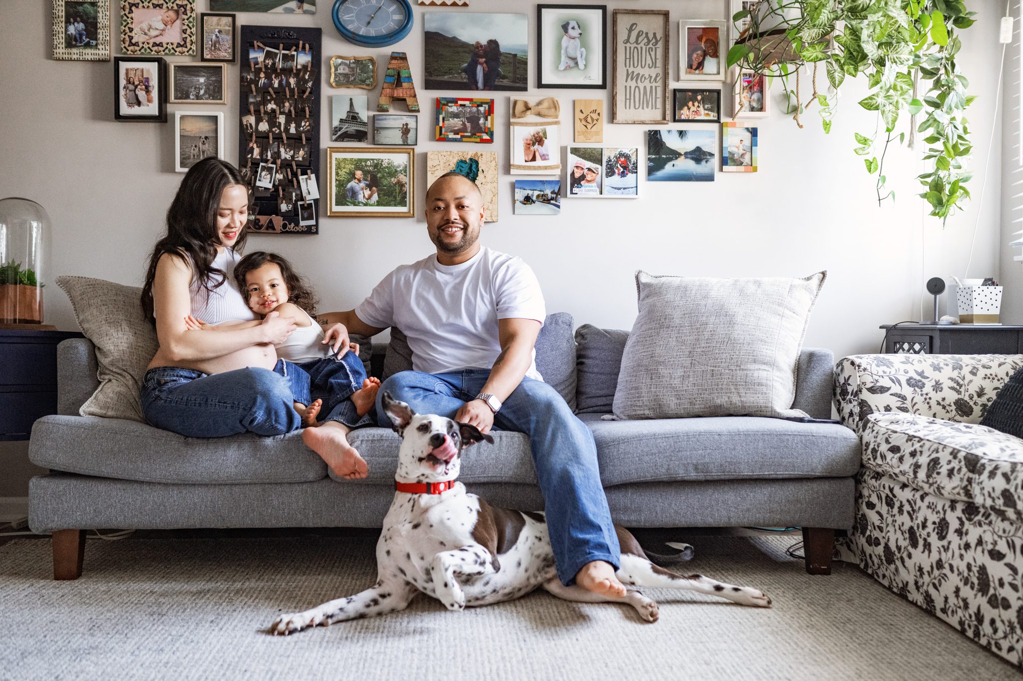 family portrait on couch in their den with their dog at their intimate in-home meternity session in scotch plains nj with joan marie photography