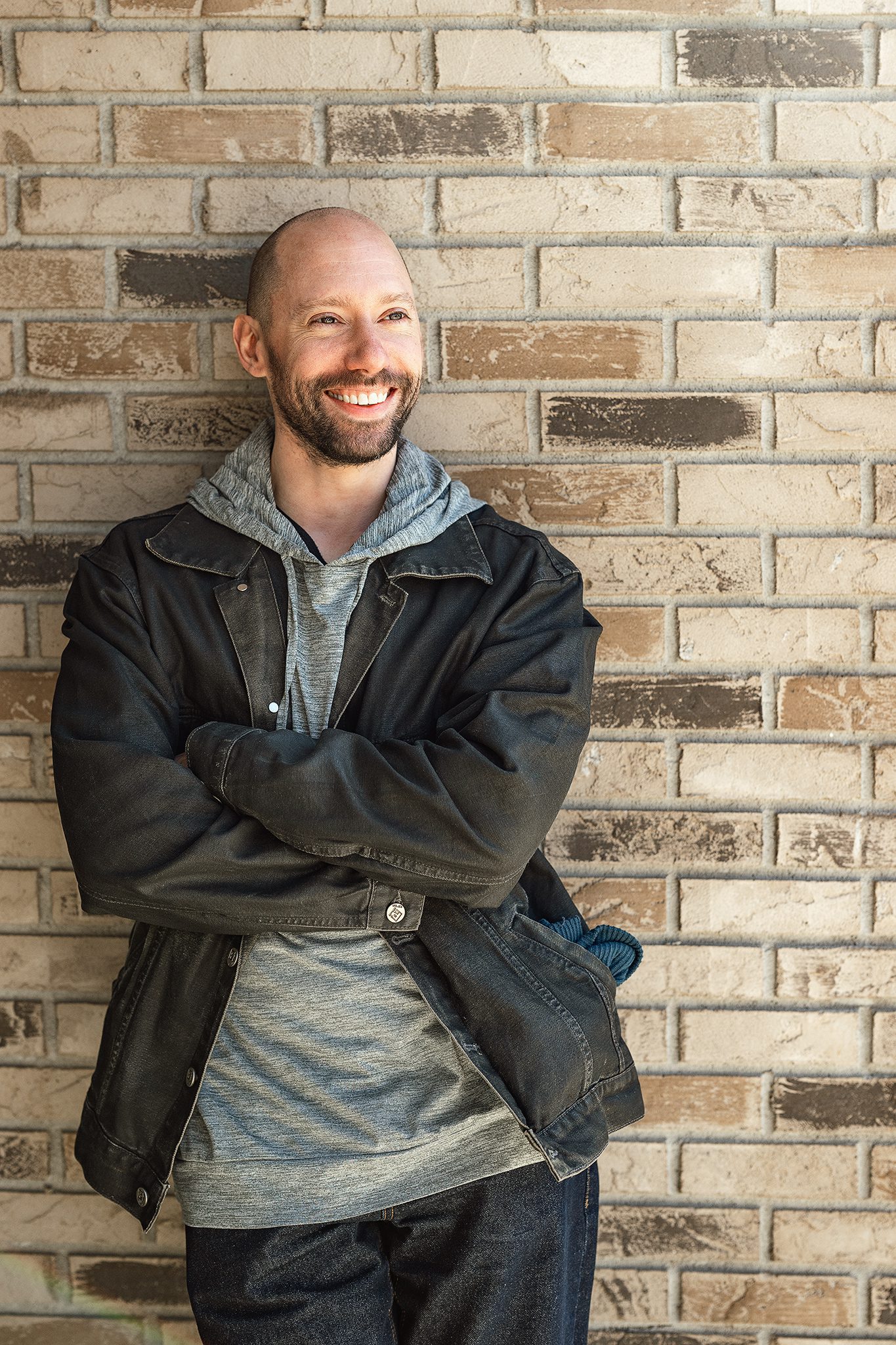 young bald man with facial hair poses for his dating profile session with joan marie photography at lokl and downtown morristown nj