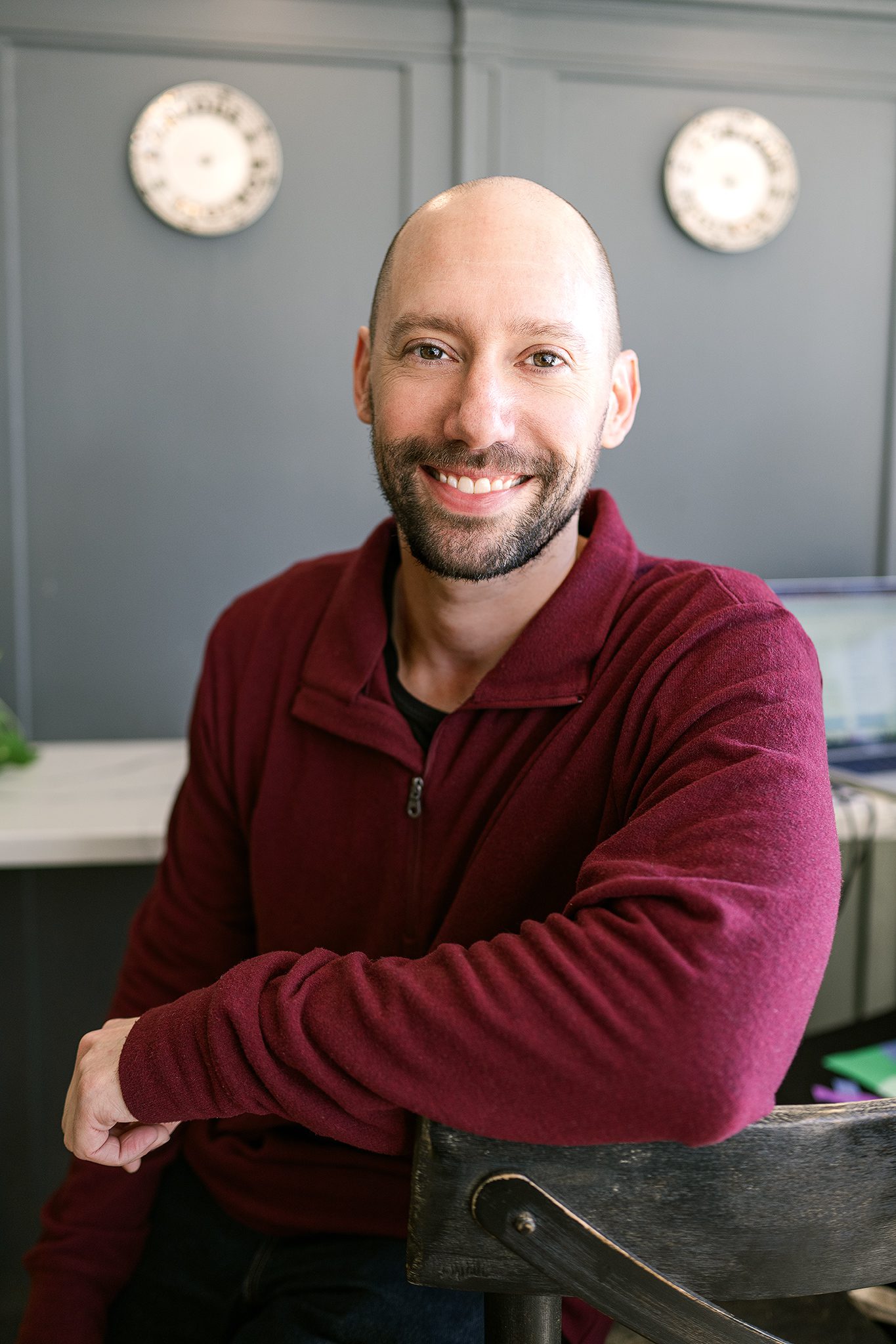 young bald man with facial hair poses for his dating profile session with joan marie photography at lokl and downtown morristown nj