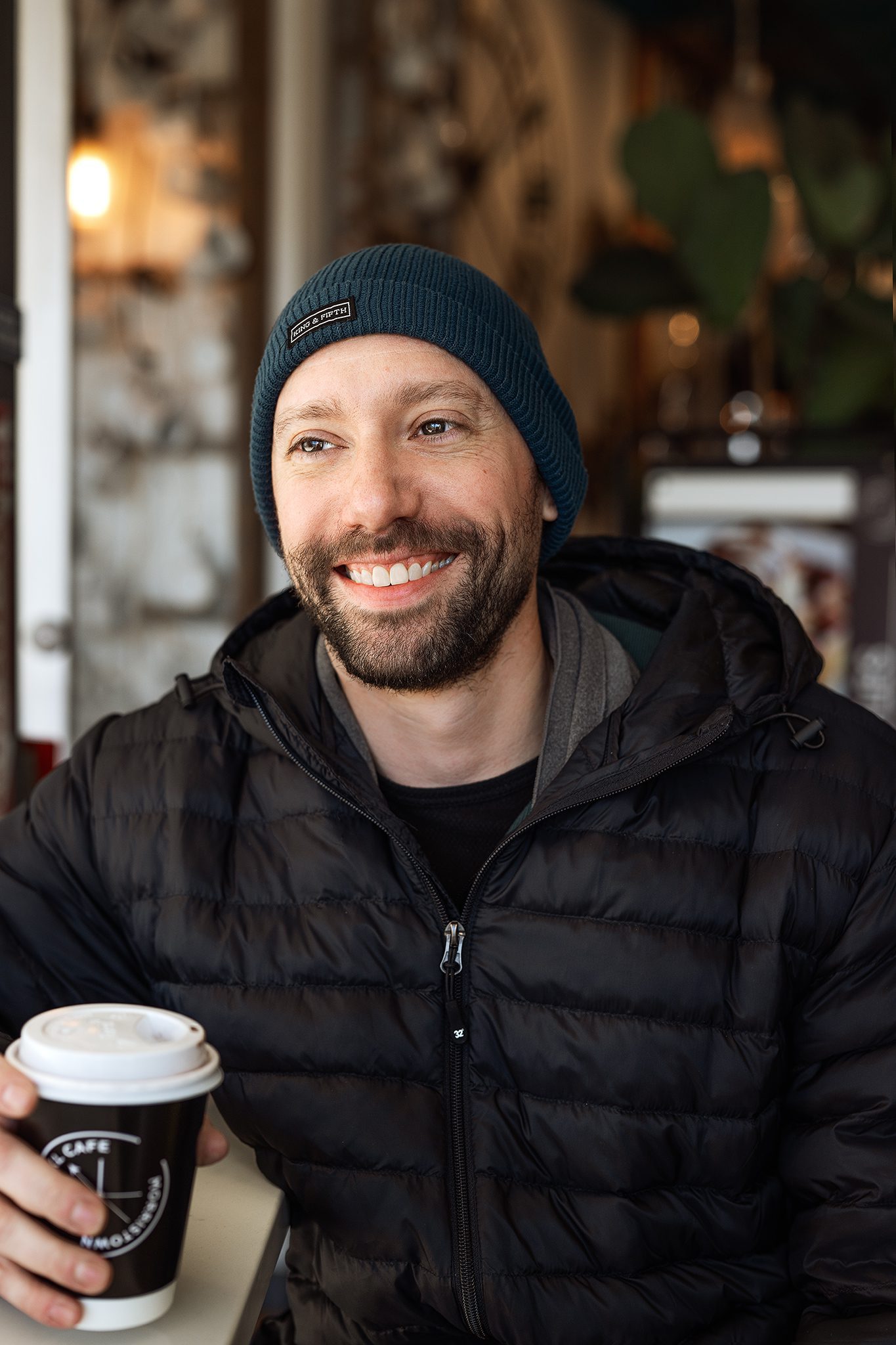young bald man with facial hair and beanie poses for his dating profile session with joan marie photography at lokl and downtown morristown nj