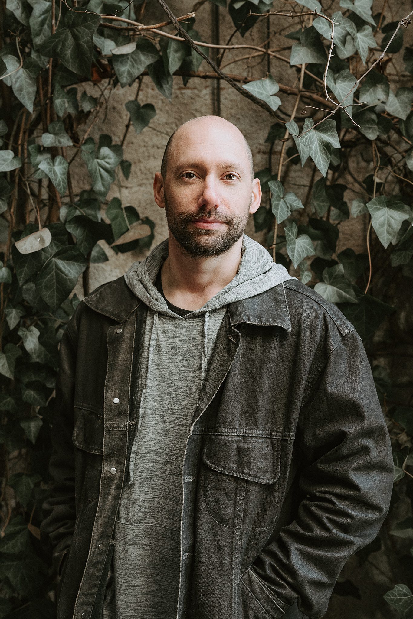 young bald man with facial hair poses for his dating profile session with joan marie photography at lokl and downtown morristown nj