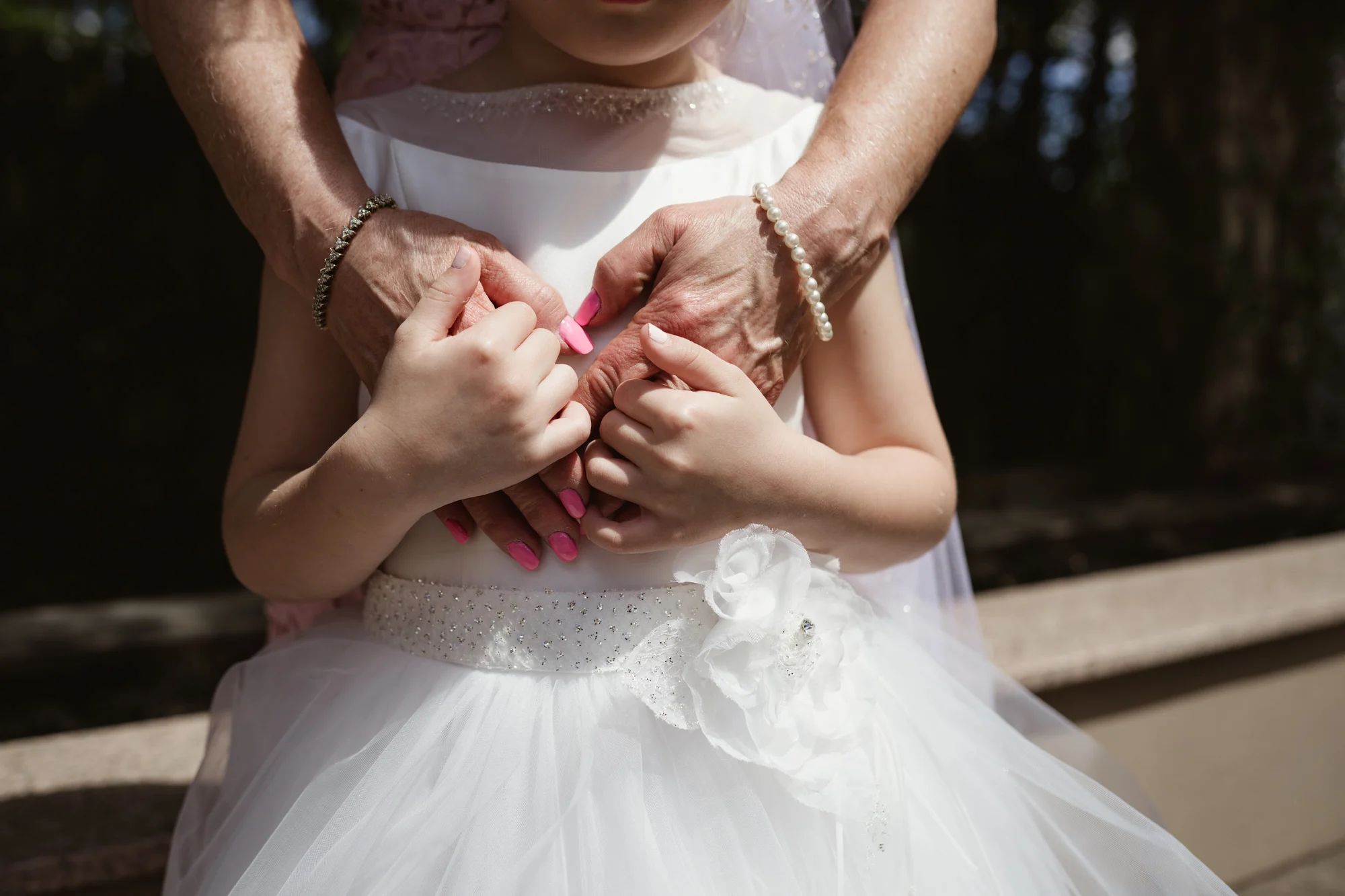little communion girl holds grandma's hands at il tulipano reception party