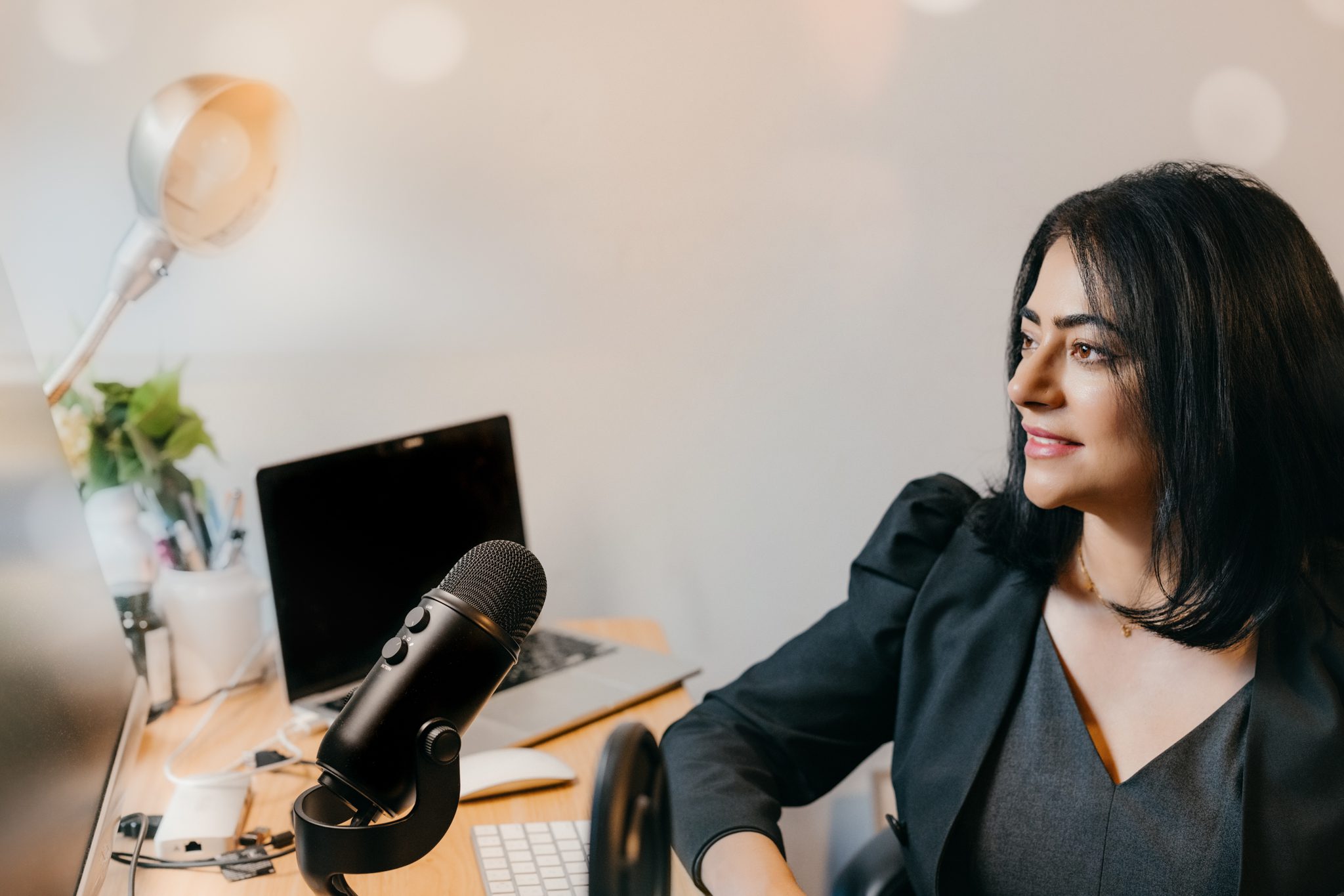 Thought leader Shalima Bhalla with Customer Signal working at a desk during her branding photography session