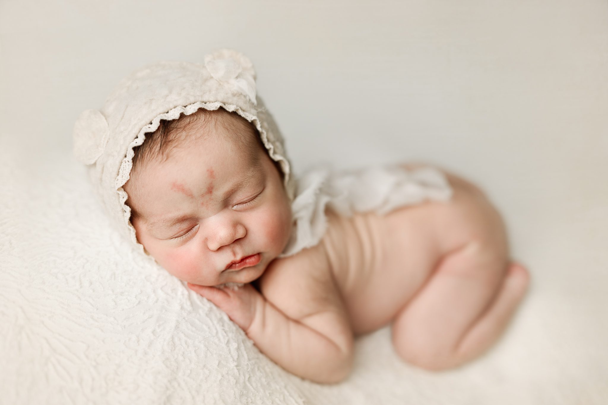 Peaceful newborn baby girl sleeping during a luxury newborn session in Scotch Plains, NJ.