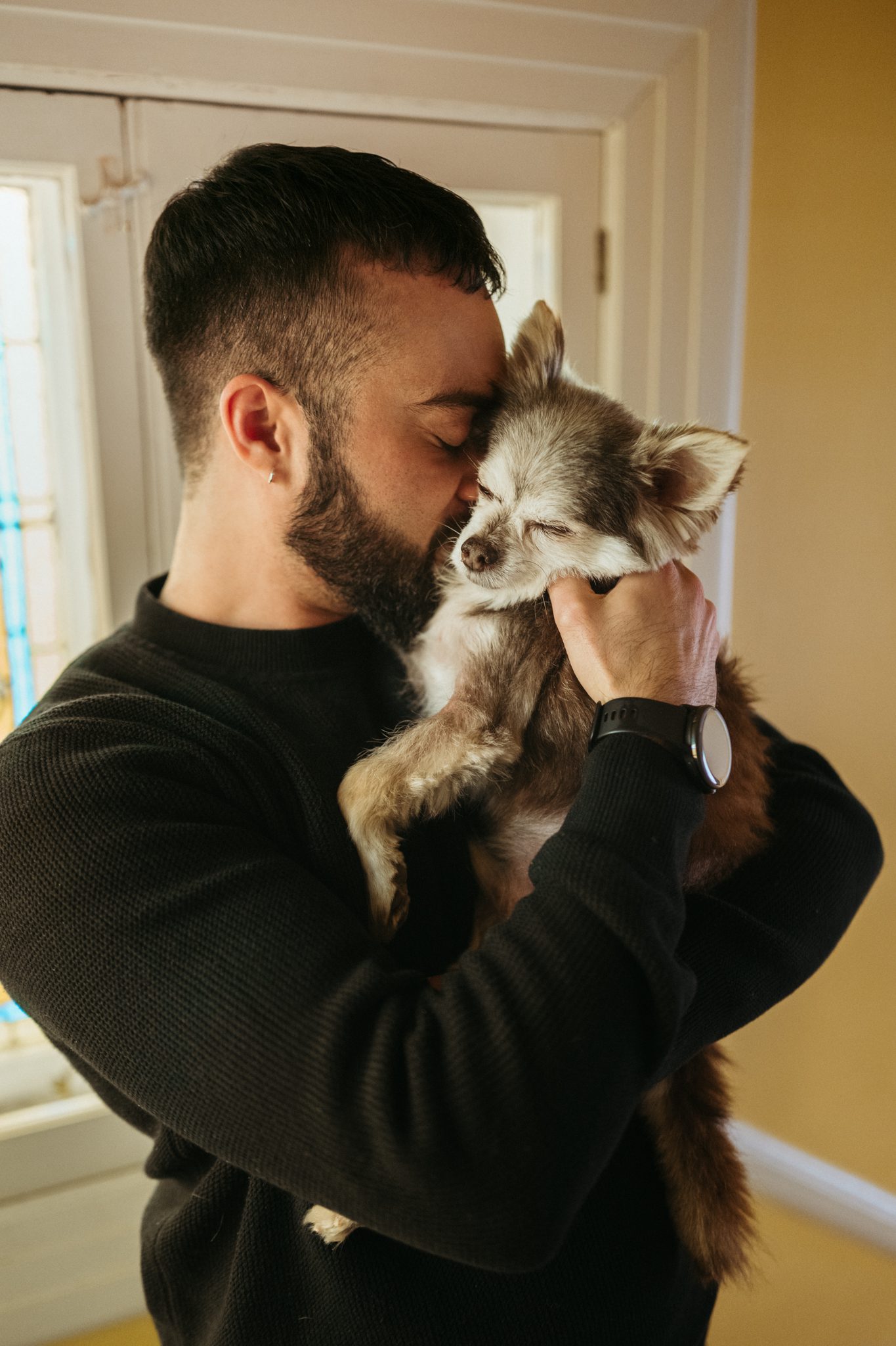 a sentimental moment between dad and dog snuggling