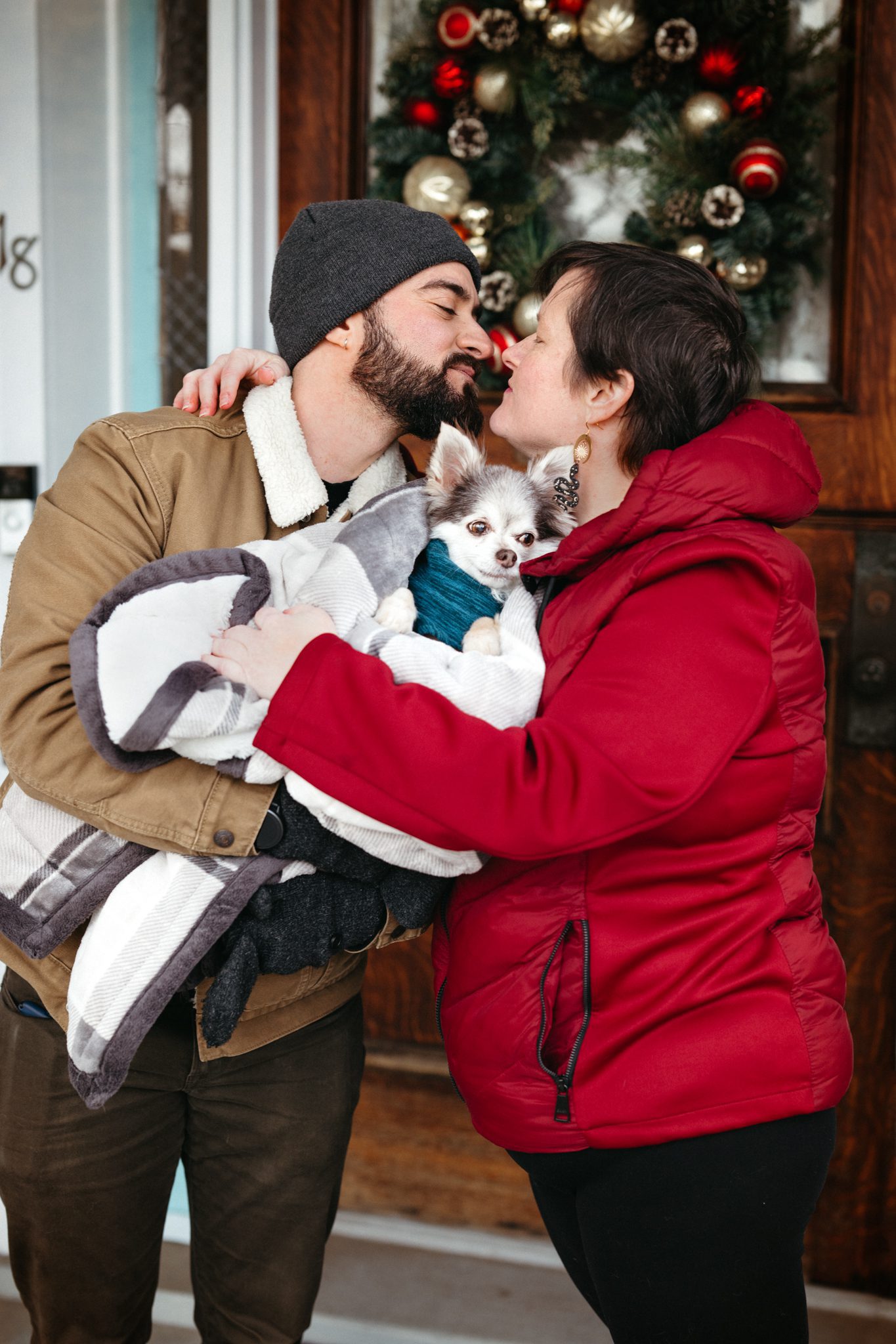 family photo of mom and dad kissing while holding their dog at their celebration of life photoshoot in Cranford NJ