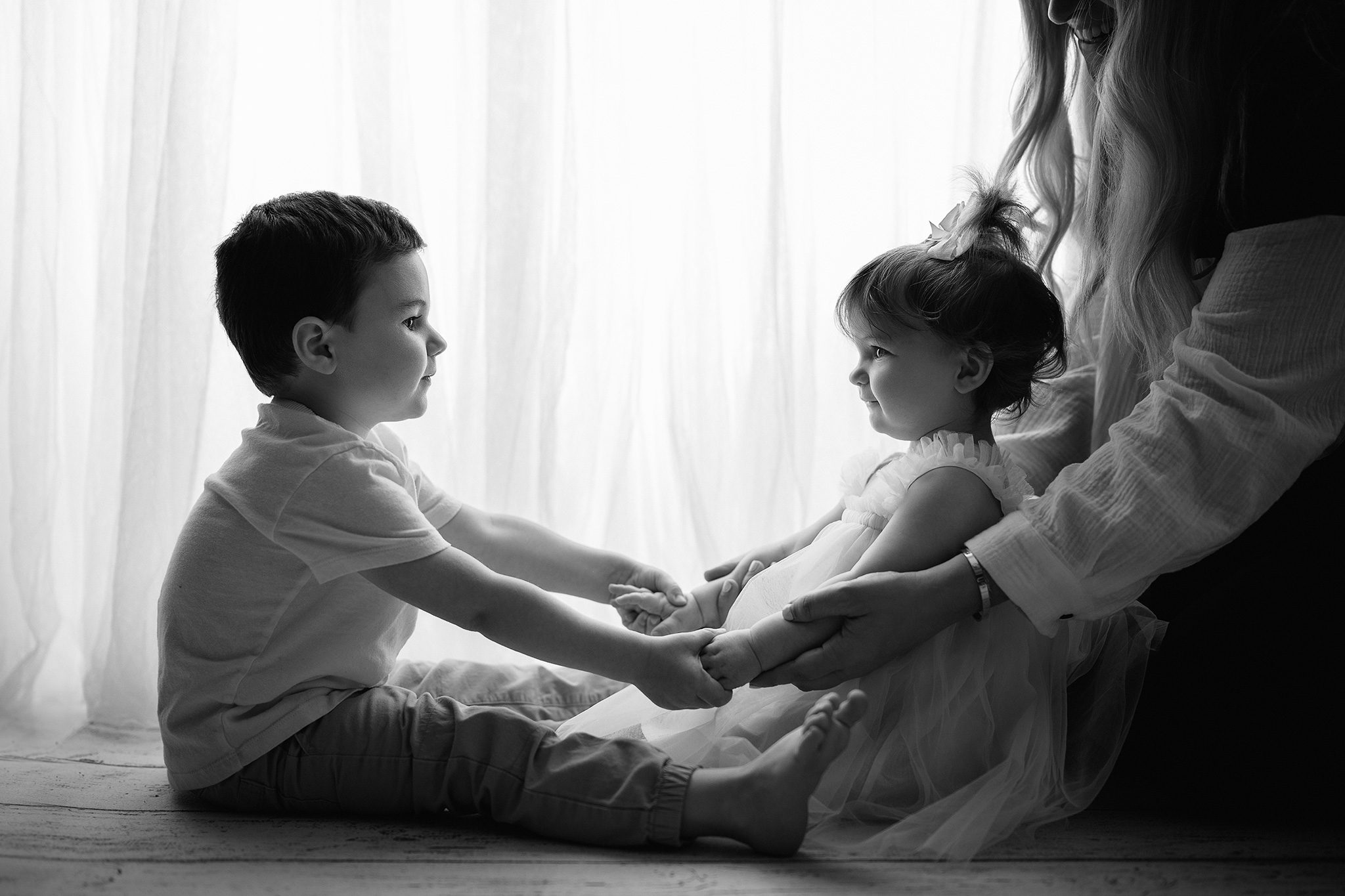 siblings holding hands at little girl's cake smash session in scotch plains
