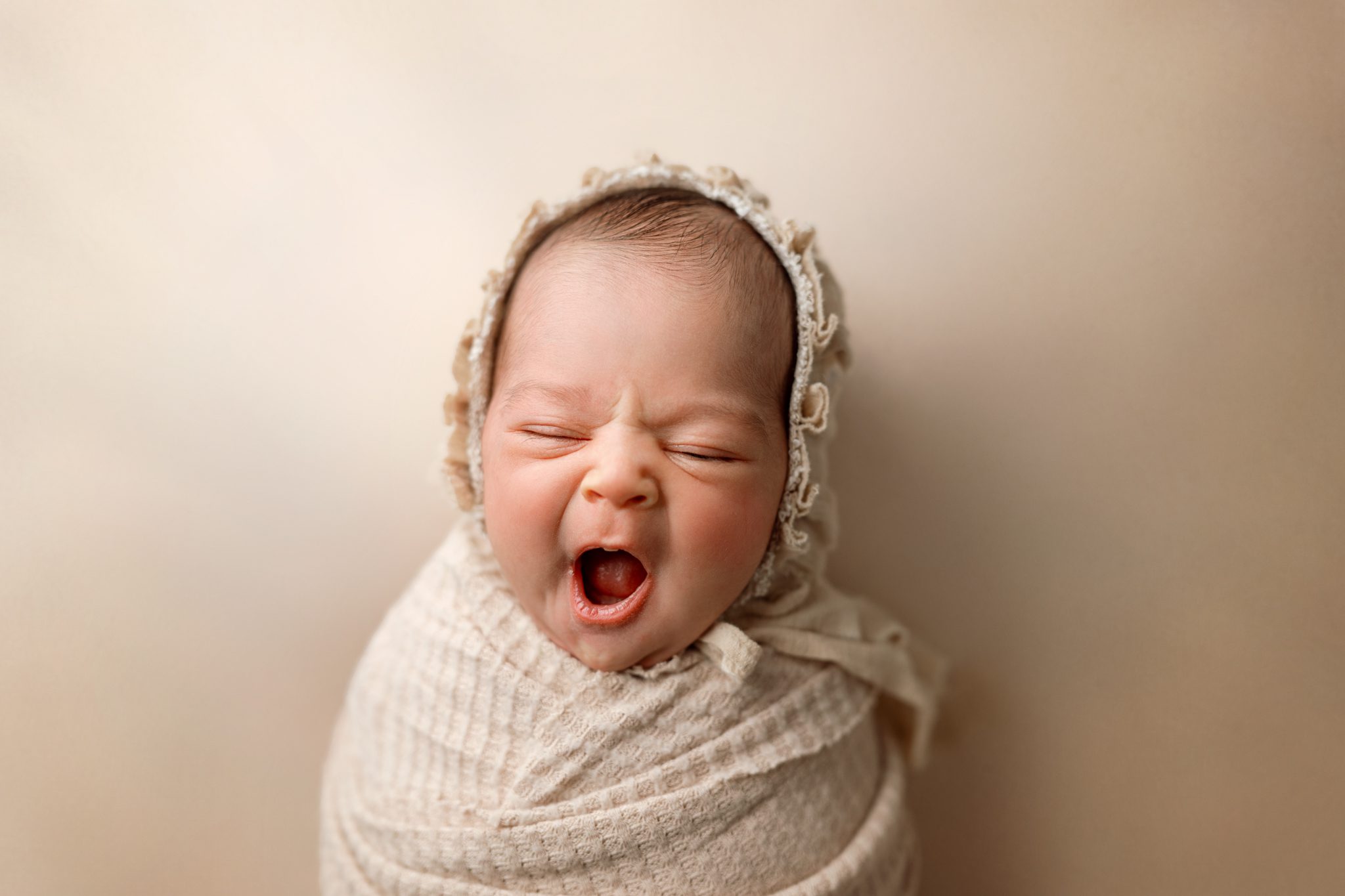 sweet little baby girl captured in a little yawn
