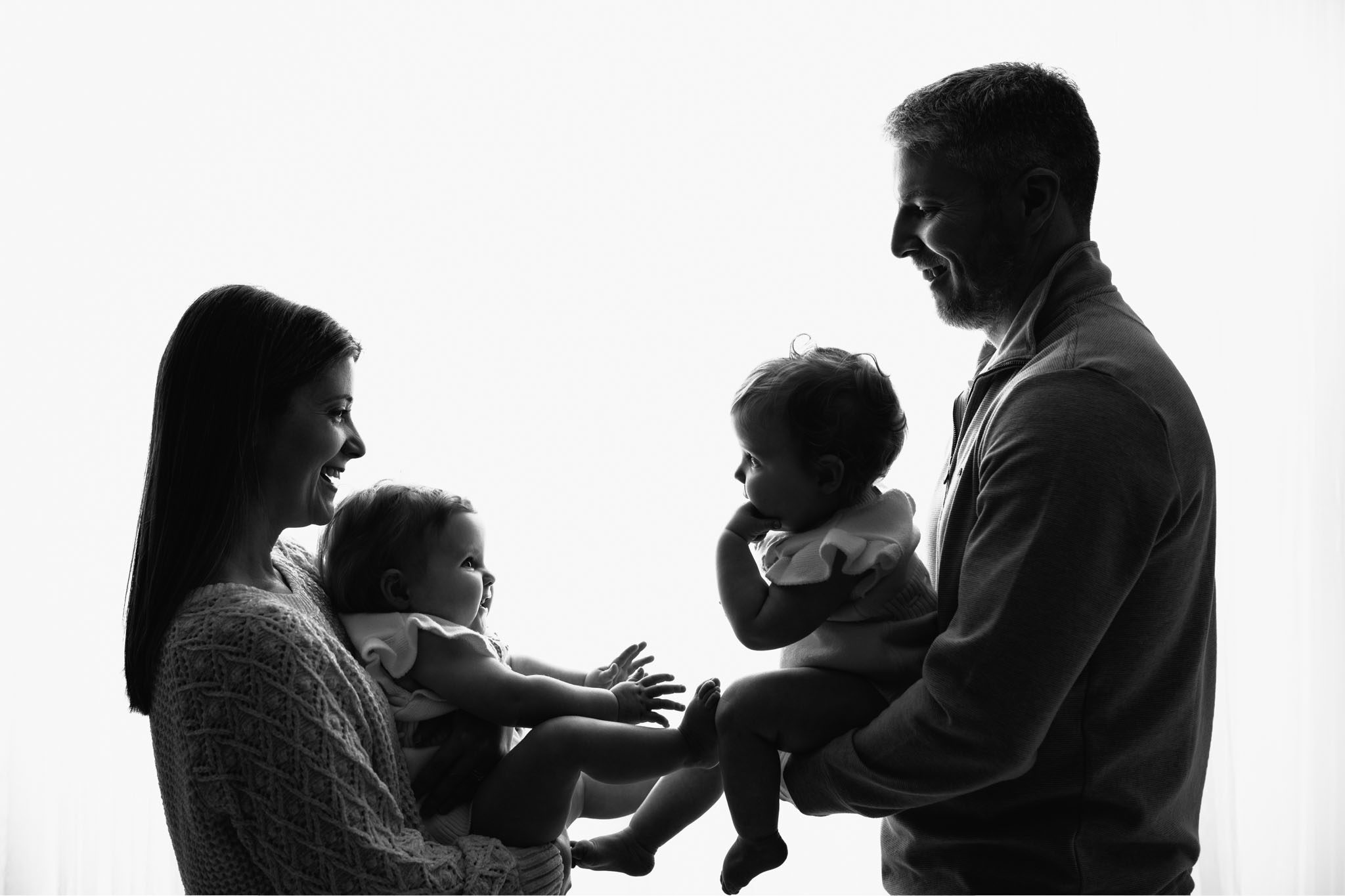 The Family Portrait A family posing together for a portrait before the twin girls' cake smash event in a professional photography studio.