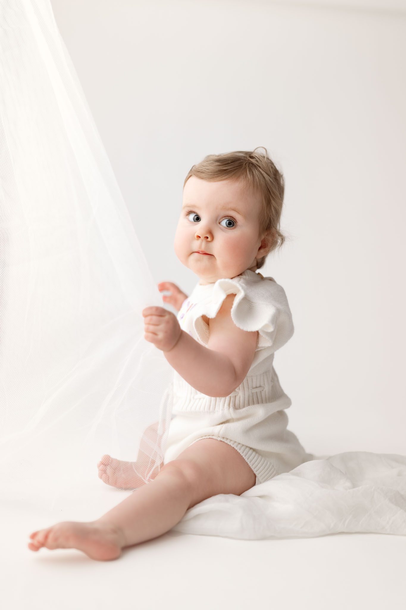 twin girl on an all white set for her 1st birthday session in scotch plains at joan marie photography