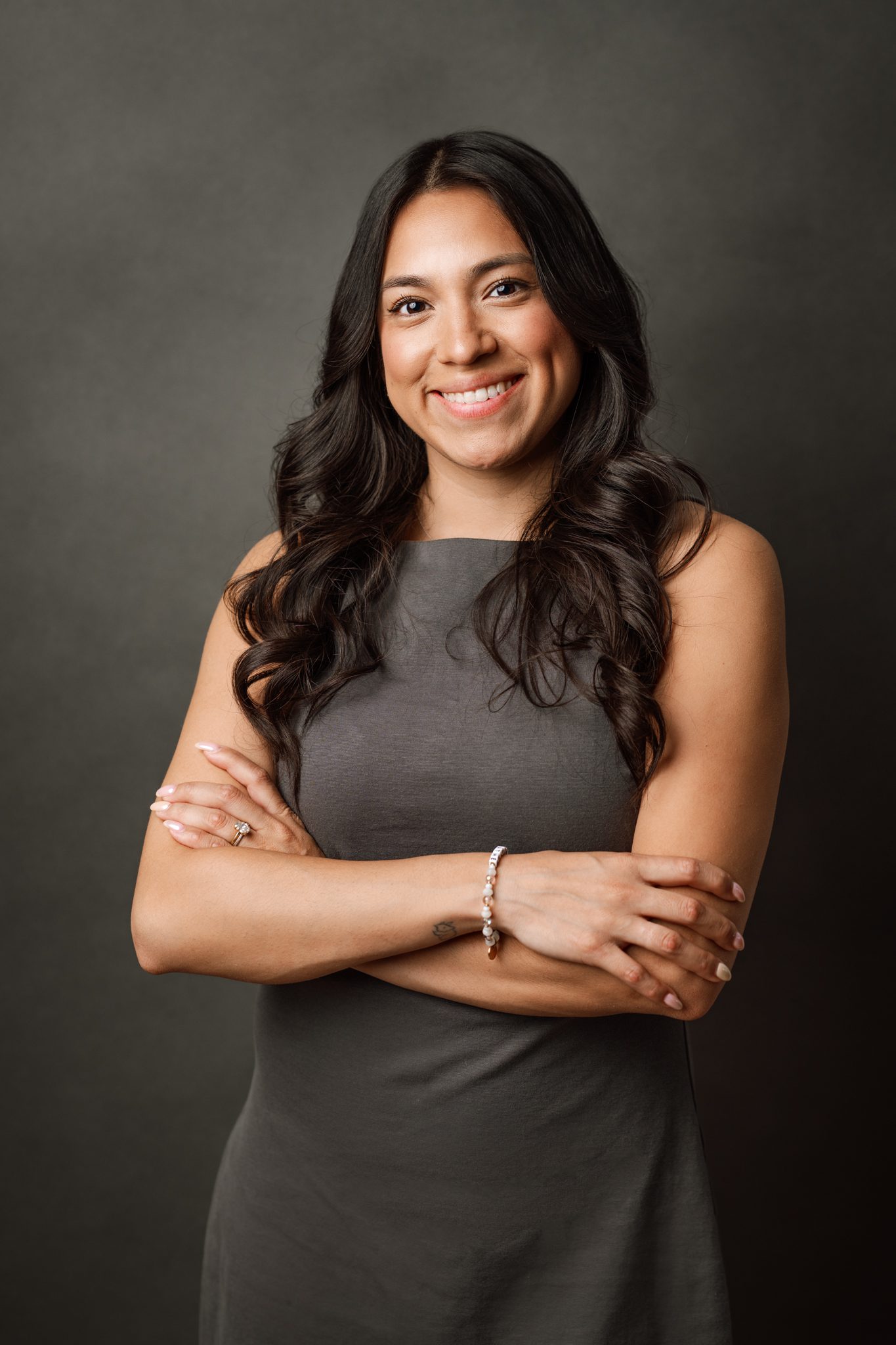 brunette woman poses for her scotch plains nj headshot on a grey backdrop