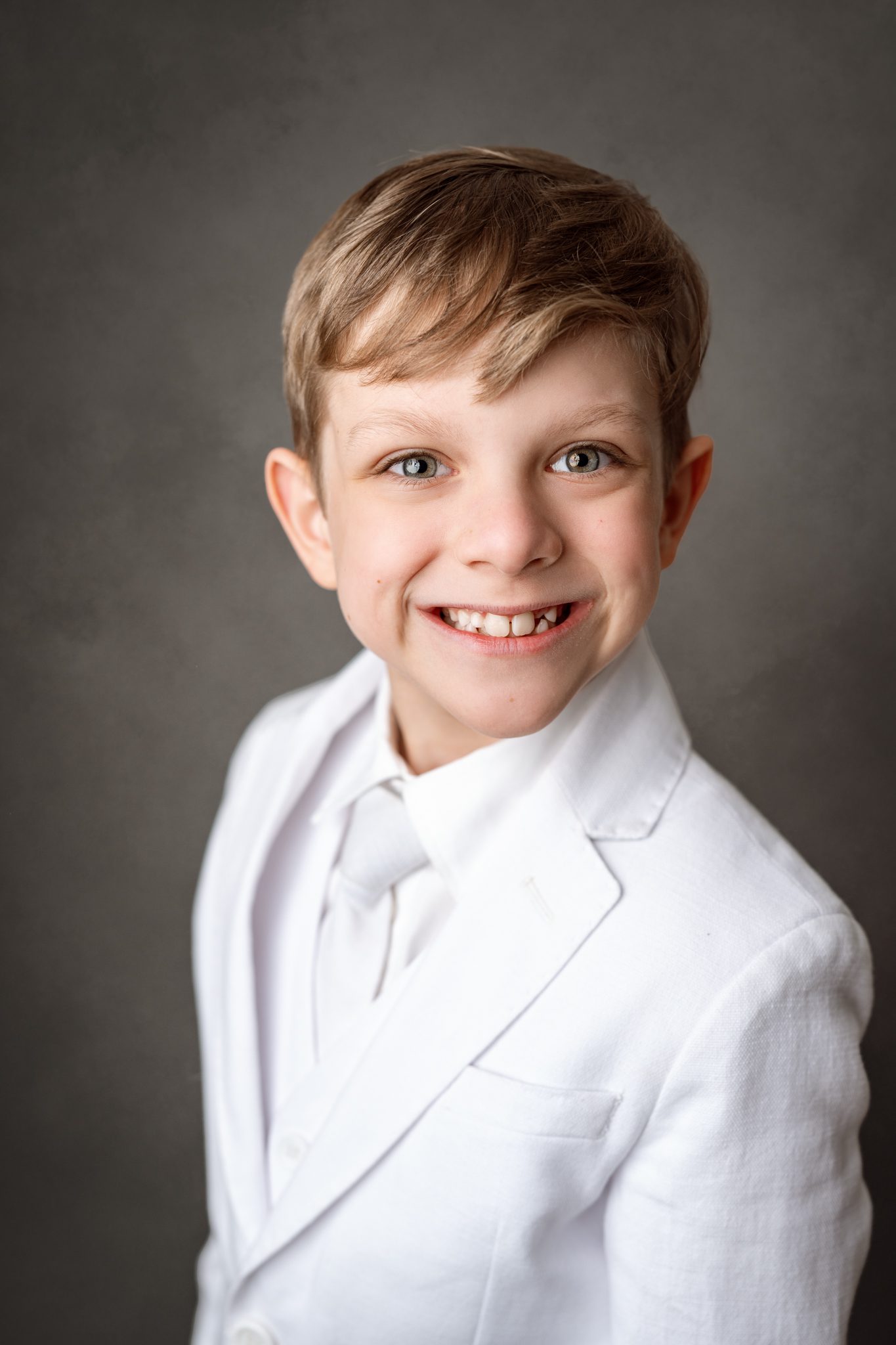 First Holy Communion Portraits of a boy posing in his white suit for his first holy communion in scotch plains nj with joan marie photography