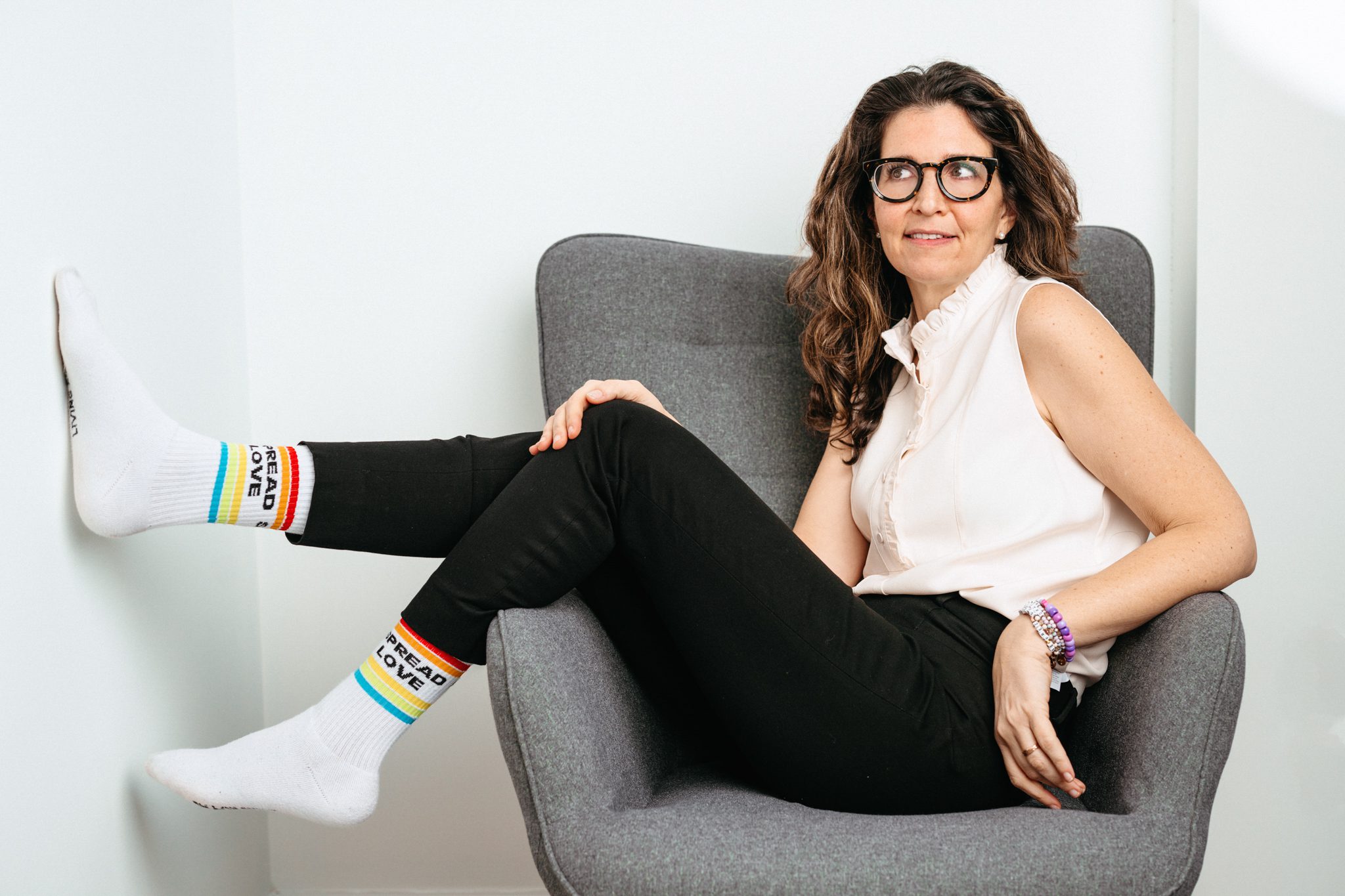 woman in chair at her personal branding portrait session with joan marie photography