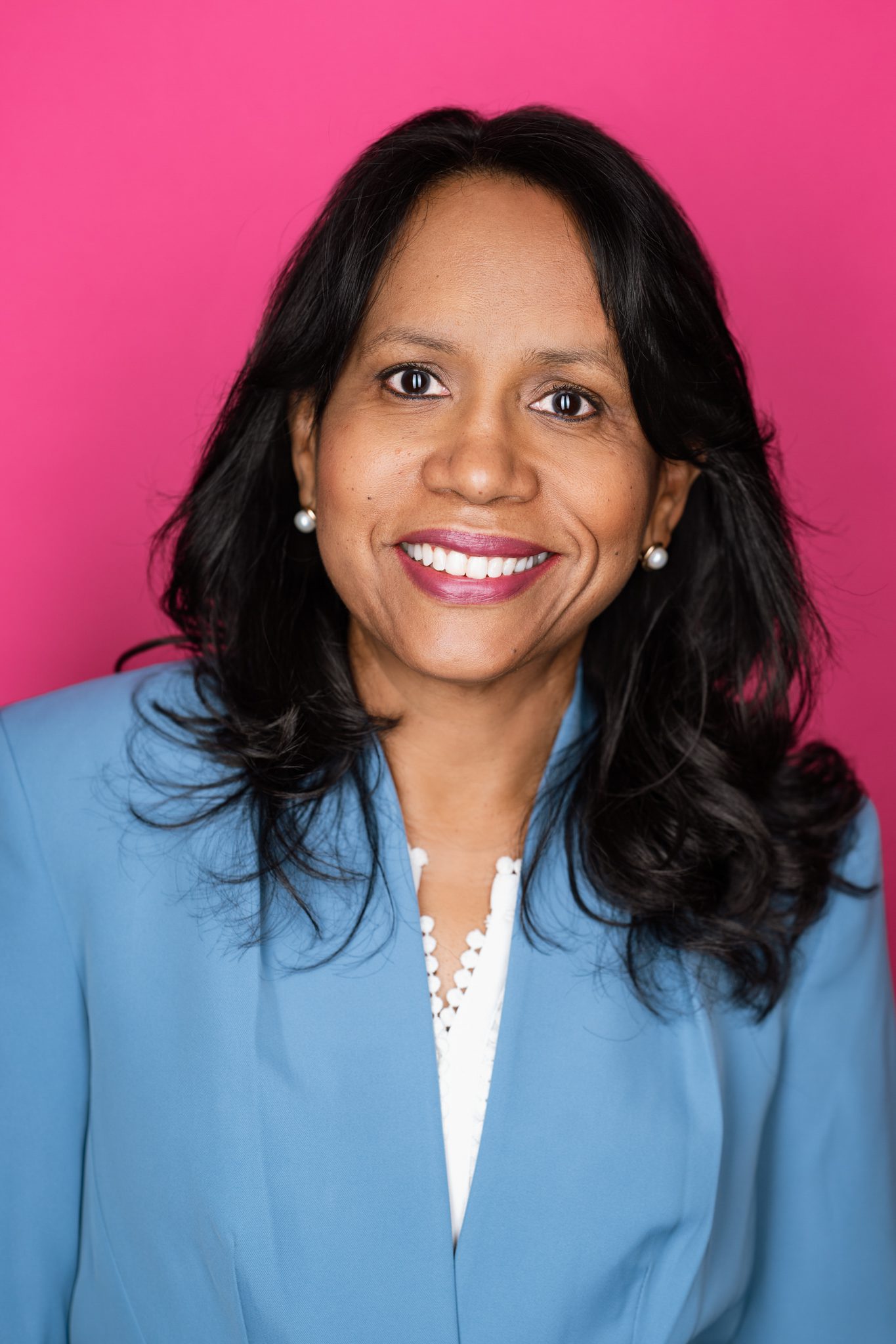 Professional headshot in Scotch Plains NJ using a hot pink backdrop and strip lighting.