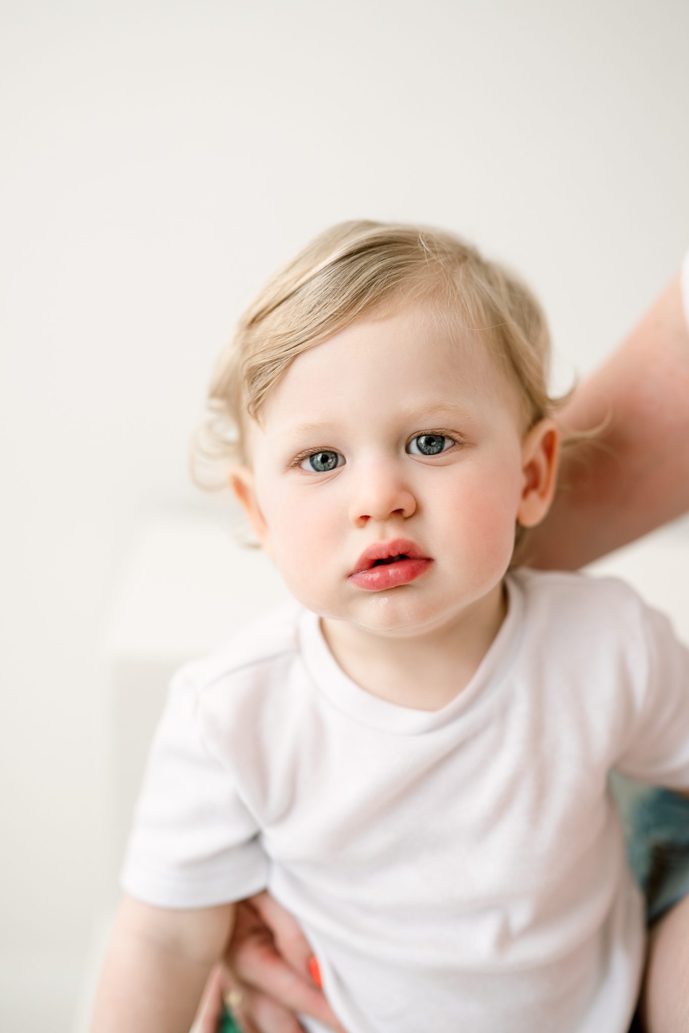 Close up portrait of a one year old boy laughing during her first birthday photoshoot