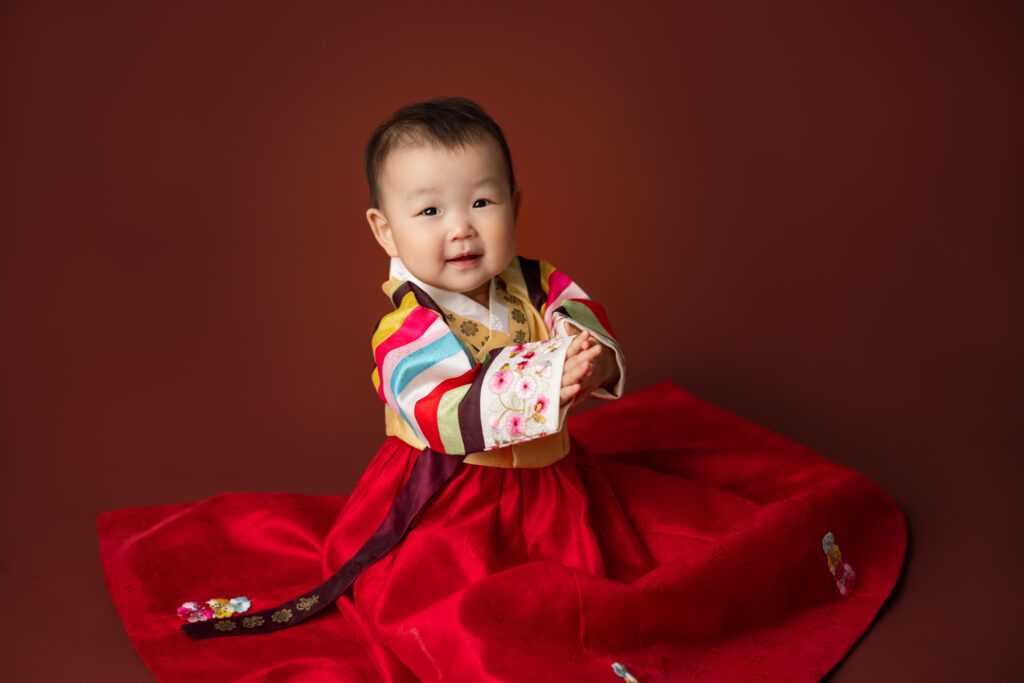 little girl in hanbok posing for her first birthday shoot in scotch plains nj with joan marie photography