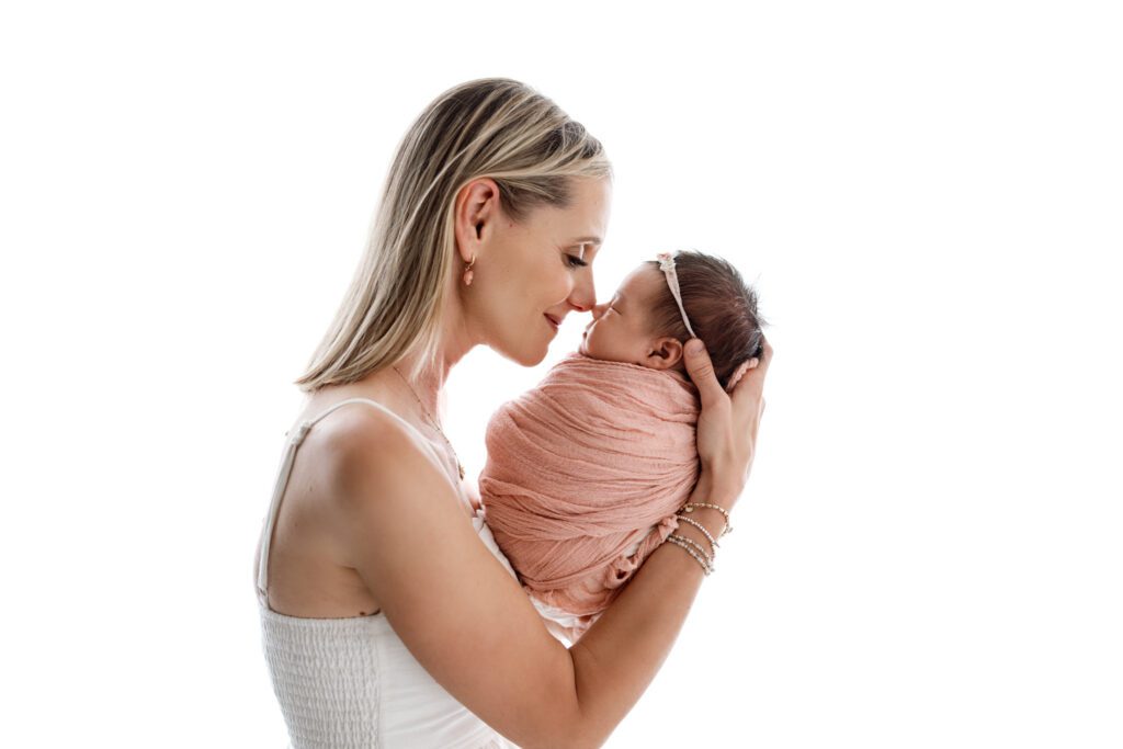 mom snuggles in close with her newest daughter