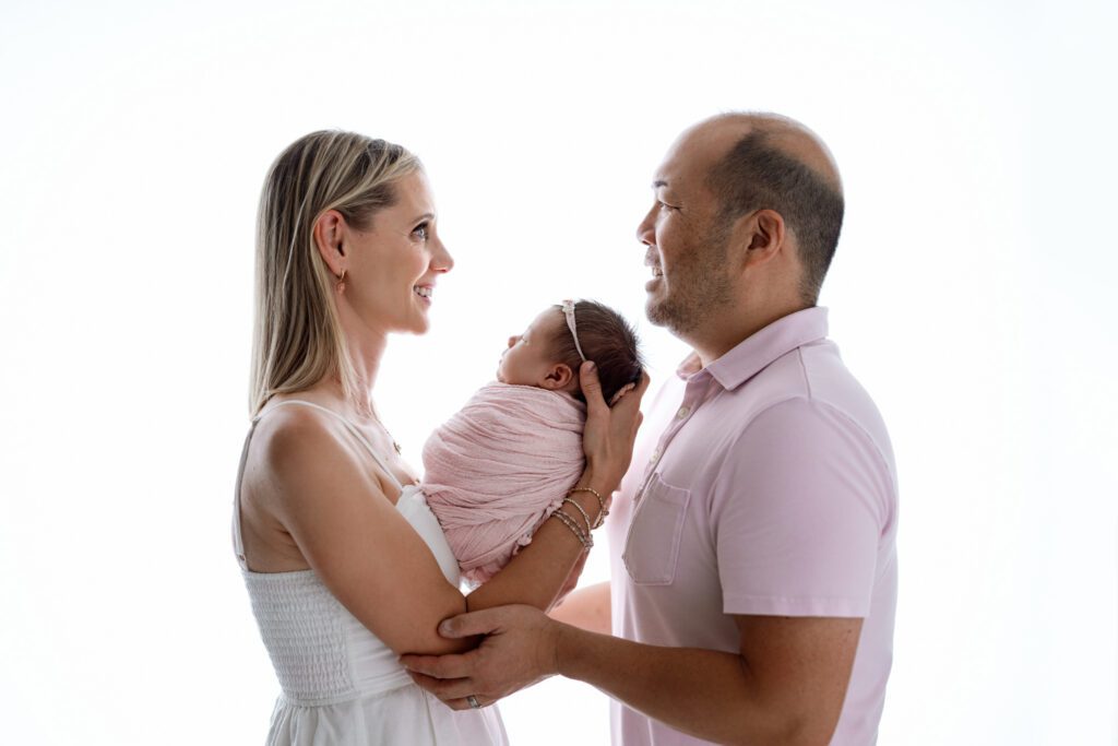 mom and dad share a special moment with their new baby