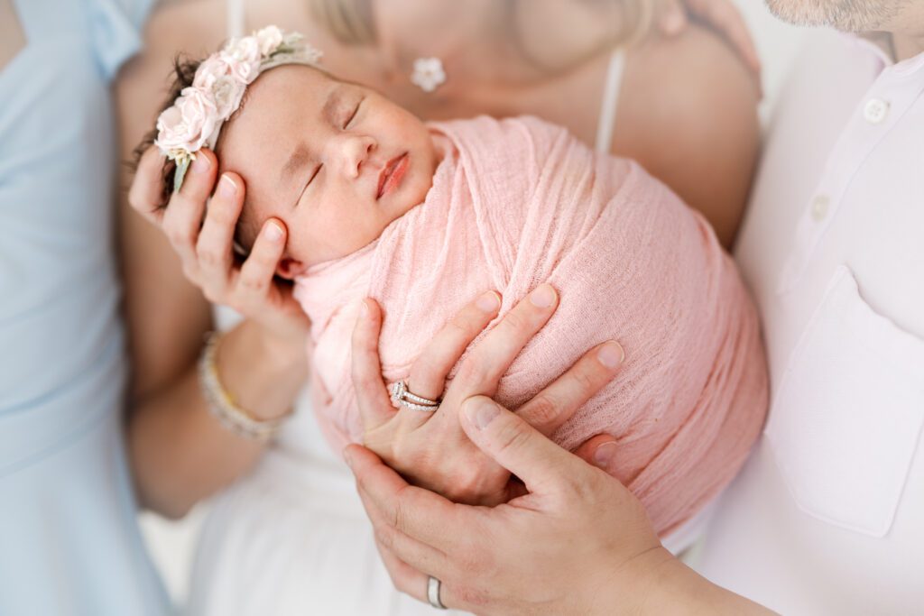 mom and dad cradle new baby at newborn photoshoot in scotch plains nj